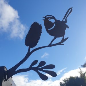 Superb Fairy Wren on a Banksia twig, laser-cut from Corten steel, rusting naturally for a decorative garden feature.