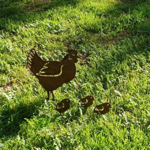 Hen Family Garden Stake made from rusted metal, featuring a standing hen and three chicks, perfect for outdoor decoration.