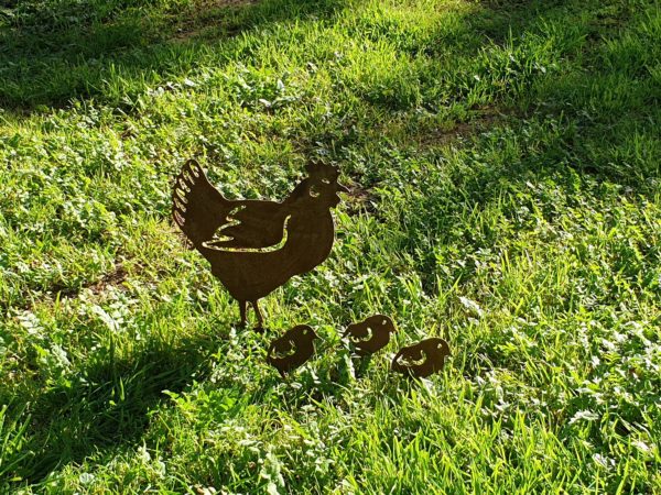 Hen Family Garden Stake made from rusted metal, featuring a standing hen and three chicks, perfect for outdoor decoration.