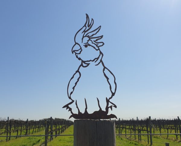 A beautiful Cockatoo Post Topper made from rusted metal, featuring a laser-cut design that enhances garden posts or fences.