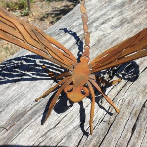 Rusted metal dragonfly garden sculpture