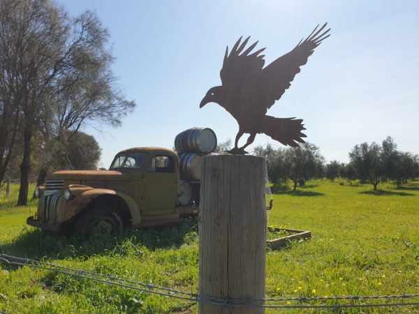 A beautifully crafted Crow Post Topper made from 1.6mm thick Corten steel, showcasing intricate laser-cut details, height 340mm, perfect for garden decoration.