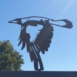 The Magpie Flying Post Topper is a beautifully crafted rusted metal garden art piece featuring a flying magpie, made from 1.6mm thick Corten steel.