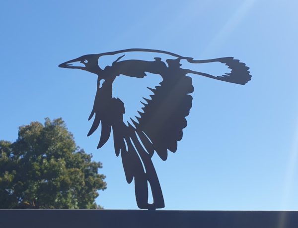 The Magpie Flying Post Topper is a beautifully crafted rusted metal garden art piece featuring a flying magpie, made from 1.6mm thick Corten steel.