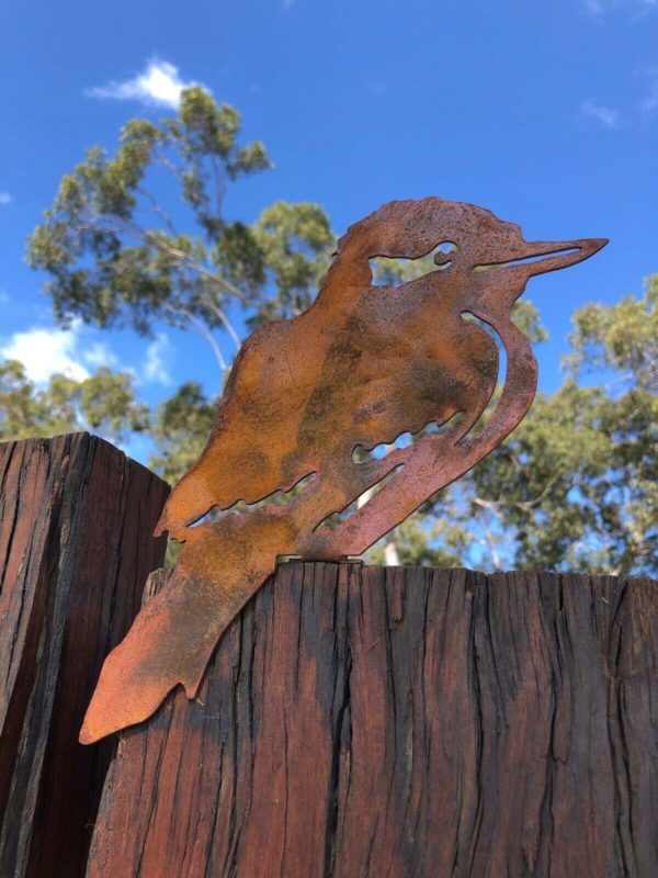 Kookaburra Post Topper perched on a wooden fence – A rusted metal Kookaburra Post Topper crafted from durable 1.6mm Corten steel, blending with the natural beauty of a wooden fence. Perfect for adding an Australian wildlife touch to your garden.