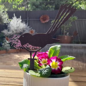 Wagtail Pot Decoration in Garden: The Wagtail Pot Decoration stands gracefully in a vibrant flower pot, showcasing its exquisite design and durable Corten steel finish, perfect for any outdoor setting.